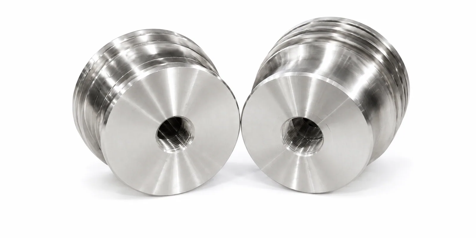 Machined steel flowline plugs showing figure-series connection profiles