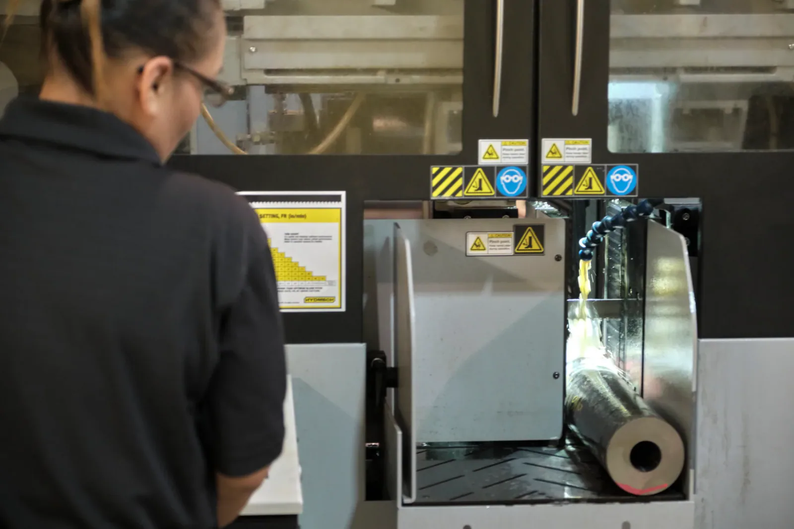 Cactus Flow Control team member machining a custom red iron component
