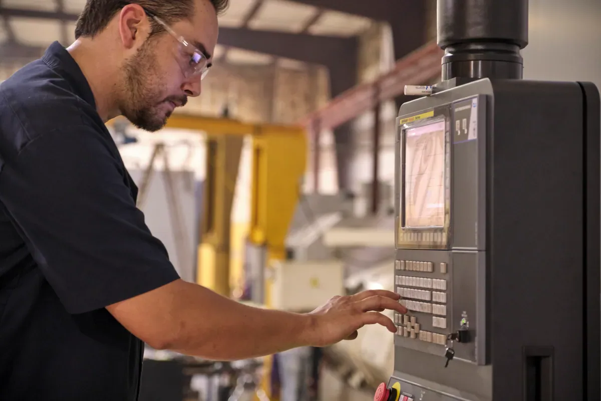 Cactus Flow Control technician operating a CNC control panel