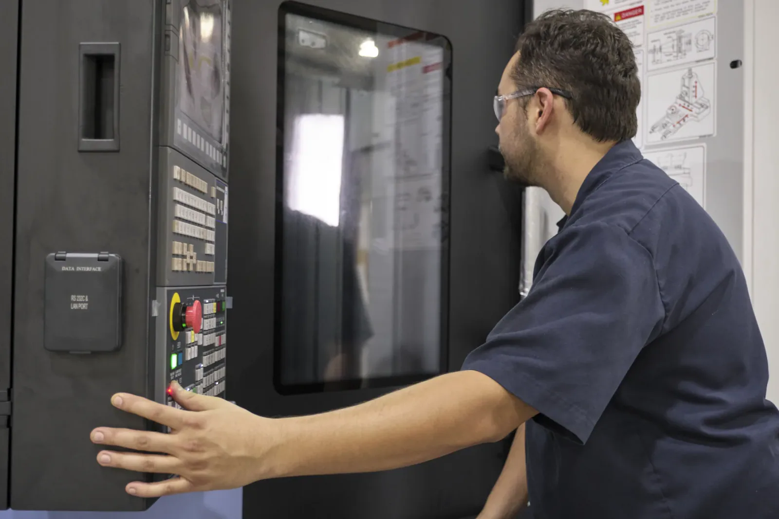 Cactus Flow Control technician inspecting a CNC machine control panel