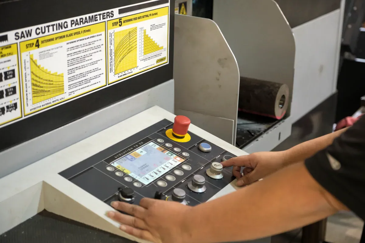 Cactus Flow Control technician using a saw control panel for material cutting